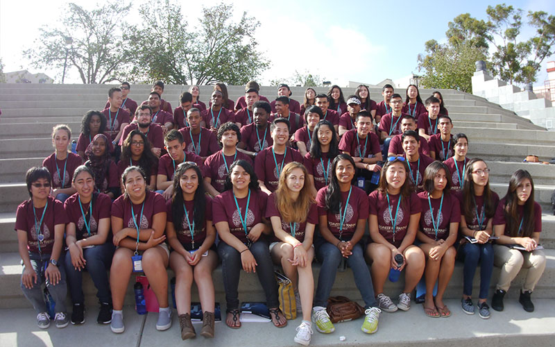 Students sitting on steps for photo