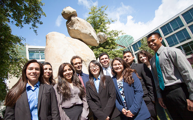 People standing in front of bear statue