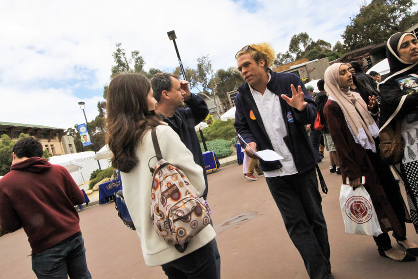 Person standing and explaining something to two other people